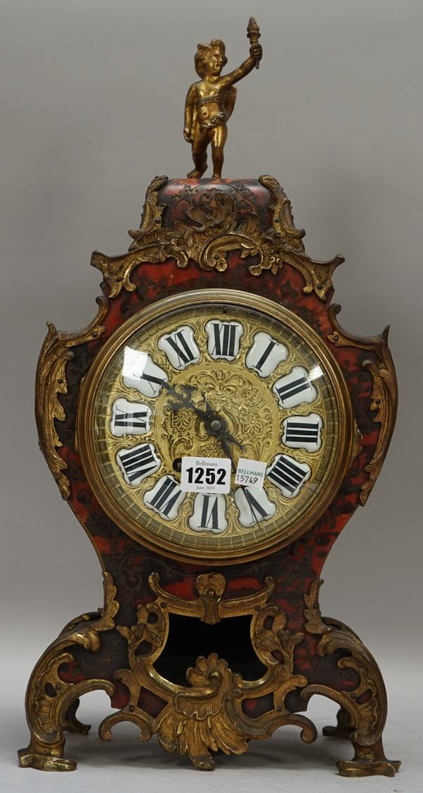 A French boulle work mantel clock of waisted form, 19th century, with cherub surmount and foliate embellished gilt metal case enclosing a two train mo