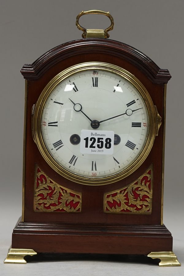 An Edwardian mahogany cased mantel clock, George III style, with domed top, enamelled dial and a French two train movement, 21cm high. (pendulum)