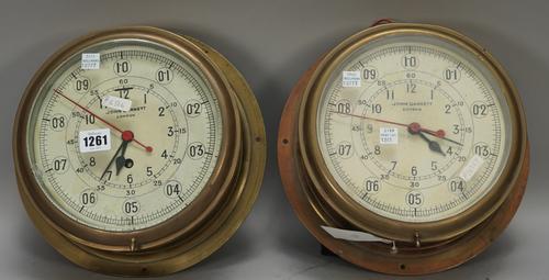 A circular brass cased wall clock by John Garnett London, with 7.5inch tin dial and single train movement and a matching brass cased wall clock fitted