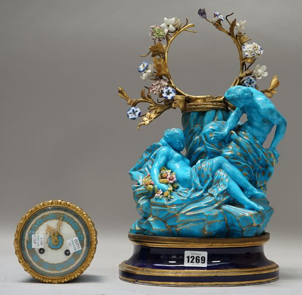 A French Sevres style porcelain mantel clock, early 20th century, the drum case flanked by ormolu and porcelain foliage over two blue and gilt classic