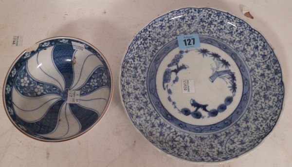 A Japanese blue and white porcelain plate, Edo period, painted in the centre with pine, prunus and bamboo against a ground filled with foliage, blue p