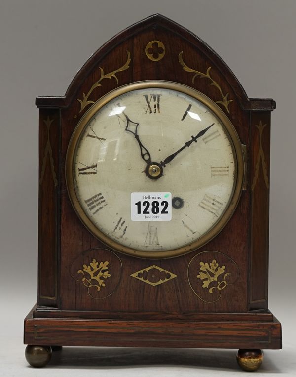 An early 19th century rosewood and brass inlaid mantel clock, with shaped case and brass chain driven fusee movement, 28cm high (pendulum, winding key