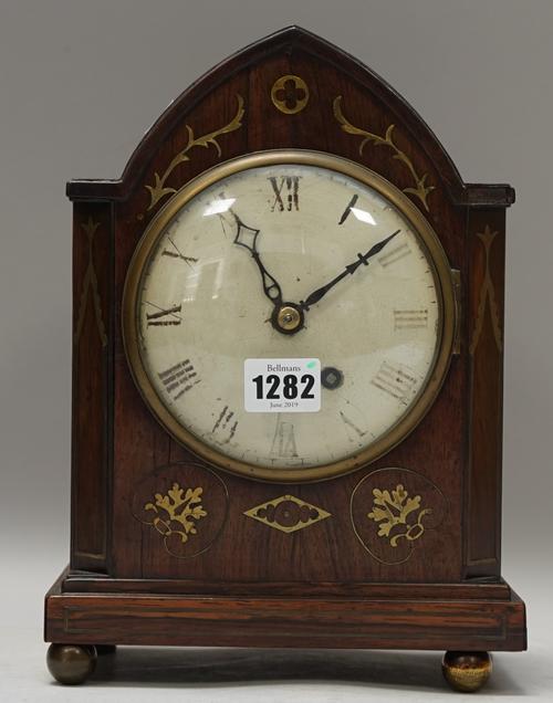 An early 19th century rosewood and brass inlaid mantel clock, with shaped case and brass chain driven fusee movement, 28cm high (pendulum, winding key