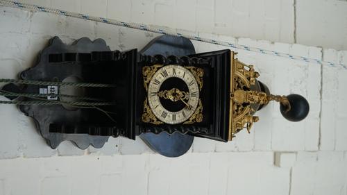 A Dutch 'Zaan' wall clock, 18th/19th century, with ebonised shaped oak case and quarter striking movement, four graduated brass weights, one pendulum,