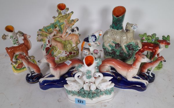 A group of 19th and 20th century Staffordshire figures including dogs, birds and cats, (7).