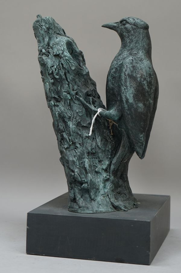 John Glazier (British, b.1930), a patinated bronze woodpecker, circa. 1990, modelled on a trunk over a grey slate style plinth, signed J.G to the cast