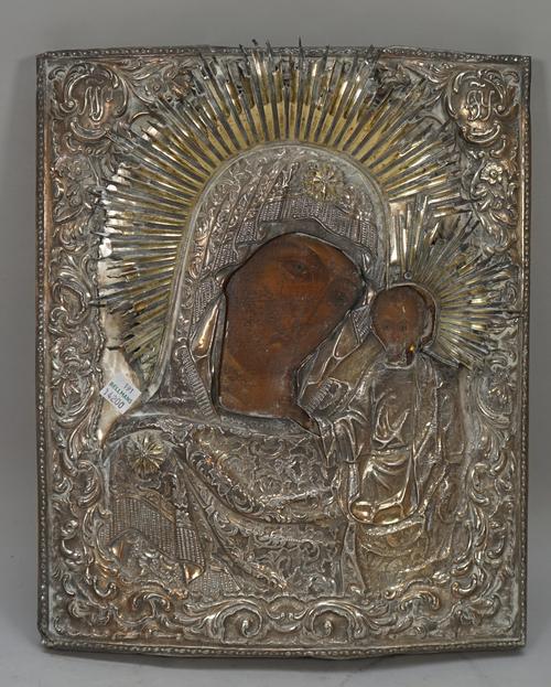 An 18th century Russian Icon with silver oklad, depicting Madonna and child, impressed marks, 33cm x 28cm.