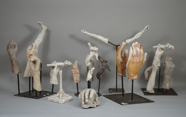 In the manner of Eduardo Paolozzi, a quantity of plaster moulded hands and legs, mounted on five separate steel bases, the largest approx 25cm. (23)