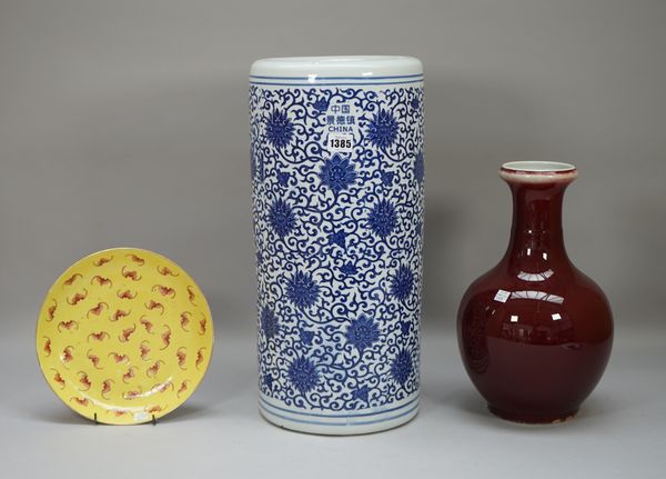 A modern Chinese porcelain blue and white cylindrical stick stand (49cm high); a modern Chinese sang de boeuf vase (34cm high) and a modern Chinese ye