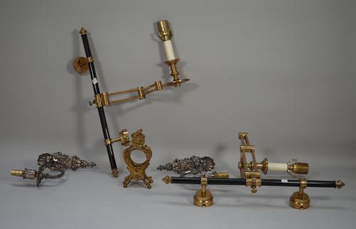 A pair of modern brass and lacquered single branch wall lights, with anglepoise arms (51cm high), a pair of white metal single branch wall lights and