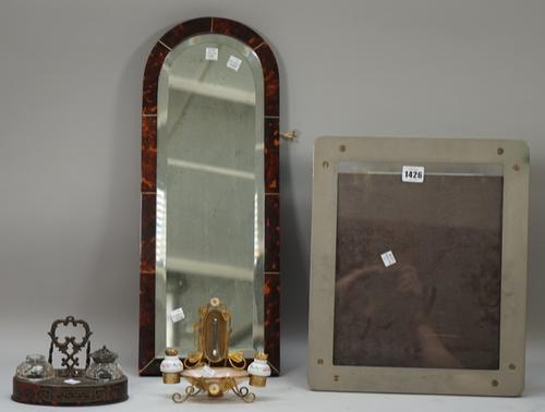 A tortoiseshell mounted wall mirror with bevelled plate, 55cm high; a Dunhill photograph frame, 37.5cm x 32cm, a small brass and shell mounted desk th
