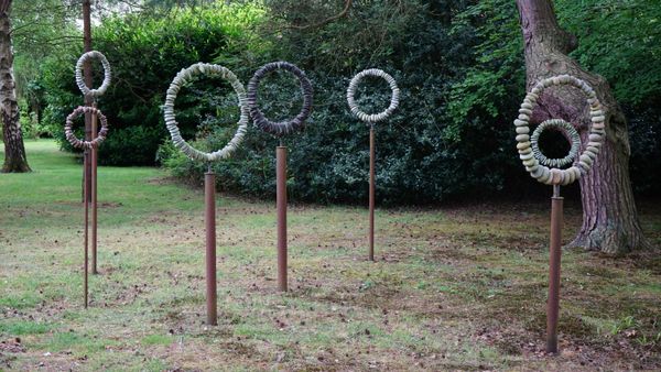 Tom Stogdon (b. 1964), Turning Circles IV, various pierced stones and steel tubes, 176cm high to 220cm high, (7). DDS