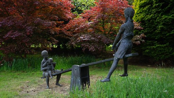 Olwen Gillmore, Three children on a seesaw, bronze with coloured patination, 163cm high x 203cm long. DDS