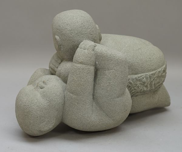 A modern stone figural group depicting two Chinese wrestlers, signed 'SOMCAIAT' 34cm wide.