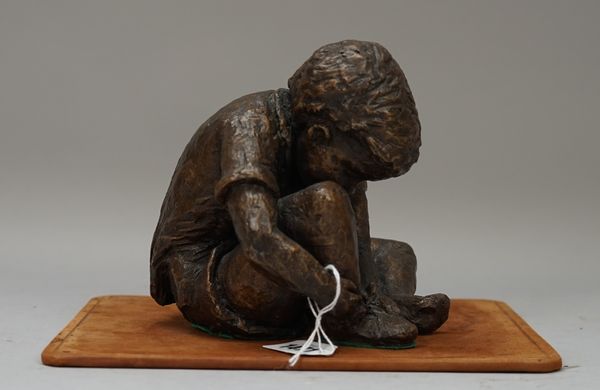 A modern bronze depicting a young boy tying his shoe-laces, signed 'Oliver' to the cast (13.5cm high) and a modern bronze female nude, crouching on a