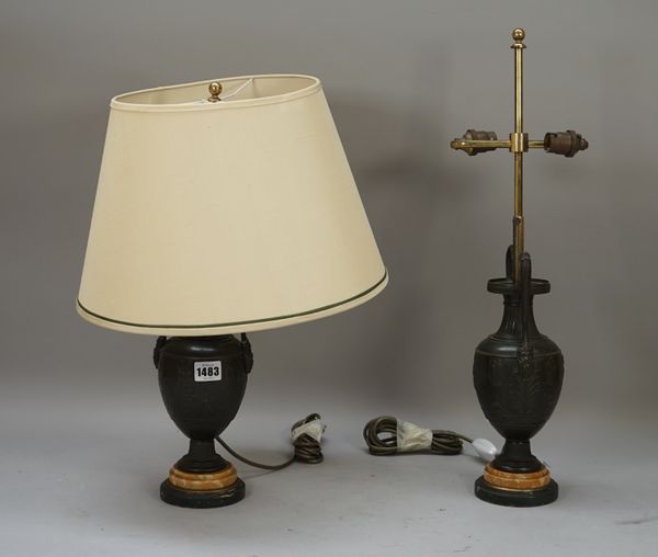 A pair of bronze urn form table lamps, on marble plinths with cream shades, 49cm high overall.