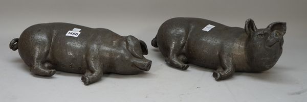 A pair of modern bronzed lead pigs, each recumbent, initialled to the base, 38cm wide, (2).