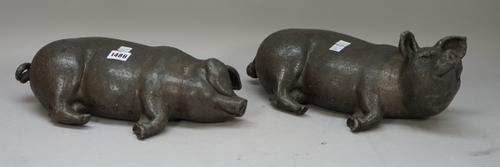 A pair of modern bronzed lead pigs, each recumbent, initialled to the base, 38cm wide, (2).