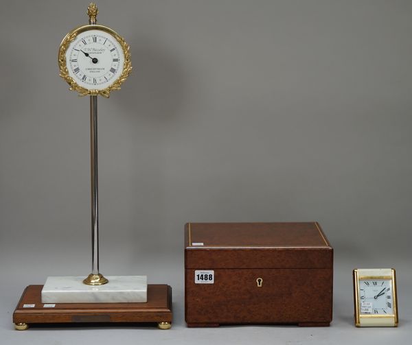 A Dunhill burr walnut humidor (24.5cm wide), a Cartier gilt metal travel alarm clock and a modern 'rise and fall' mantel clock by T.W. Bazeley. (3).