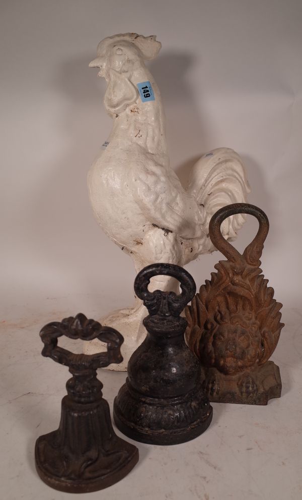 A 20th century white painted cast iron figure of a cockerel 54cm high and a group of three cast iron door stops. (4).