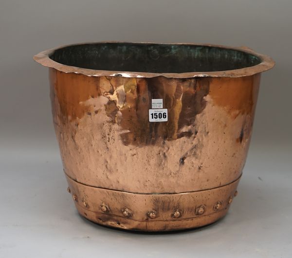 A copper log basket, 19th century, with rivetted band to the base and an out turned rim, 46cm diameter, 30.5cm high.