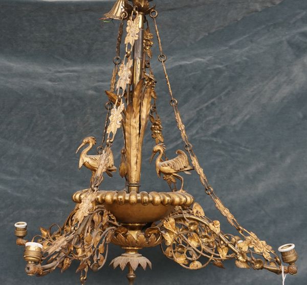 A French gilt metal four branch chandelier, the central pole cast with bullrushes over a bowl surrounded by three herons, issuing four shaped arms det