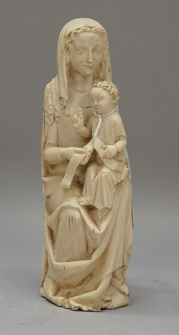 A French 18th century ivory figure group depicting Madonna and Child, 20cm high.