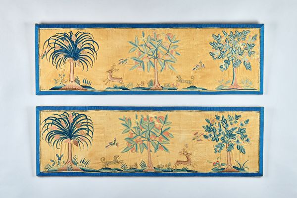 A pair of 18th century needlework panels, each depicting dog chasing a stag between three tall trees within a wide blue border, 122cm x 38cm, (2).  Il