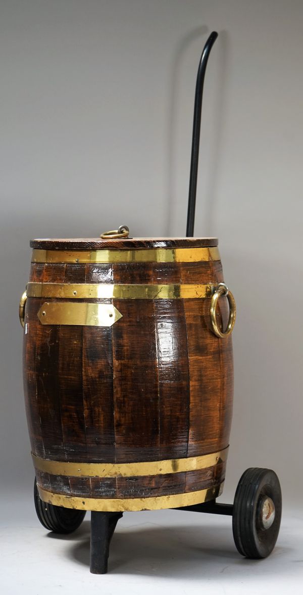 A coopered brass and oak ice bucket on wheeled stand, the bucket 35cm diameter x 43cm high.