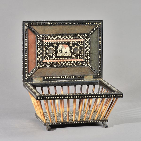 A 19th century Anglo Indian/ Sri Lankan bone inlaid ebony and porcupine quill box, of open sarcophagus form, 27cm wide x 14cm high.