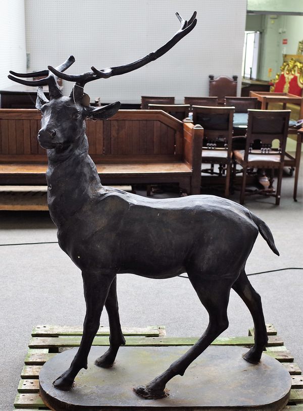 A cast metal figure of a standing stag on an oval base, 102cm wide x 145cm high.