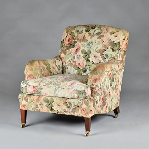 Howard & Son's, Berner's Street; an easy armchair on tapering square mahogany supports, stamped to back leg and castors, 78cm wide x 86cm high.  Illus