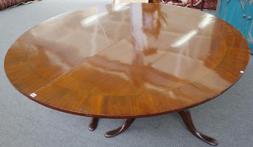 A pair of 18th century and later mahogany D end dining table sections, each on turned column and tripod base, each 183cm wide x 71cm high. (2)