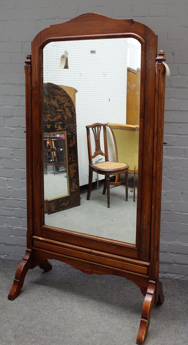 A 19th century pitch pine cheval mirror, with bevelled plate on canted block supports, 100cm wide x 180cm high.  28