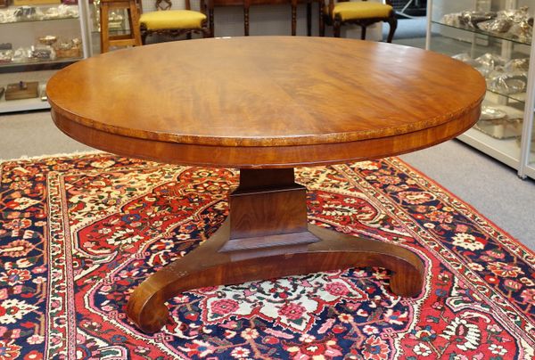 A George IV mahogany centre table, the circular snap top on three inswept supports, 134cm diameter x 74cm high.