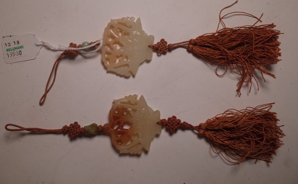 A pair of Chinese jade pendants, each pierced and carved as a basket of flowers, with silk knots and tassels, pendant 5cm. high,(2).