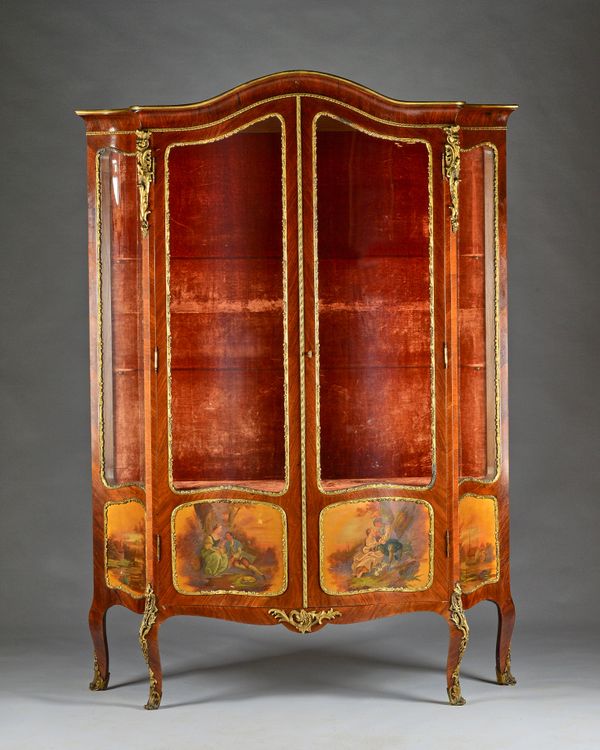 A late 19th century French gilt metal mounted mahogany serpentine framed vitrine, the pair of glazed doors over four Vernis Martin panels, 142cm wide