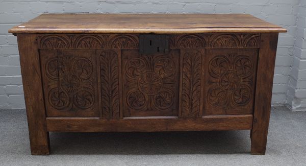 A 17th century oak coffer, with carved triple panel front, on block feet, 146cm wide x 75m high.   49