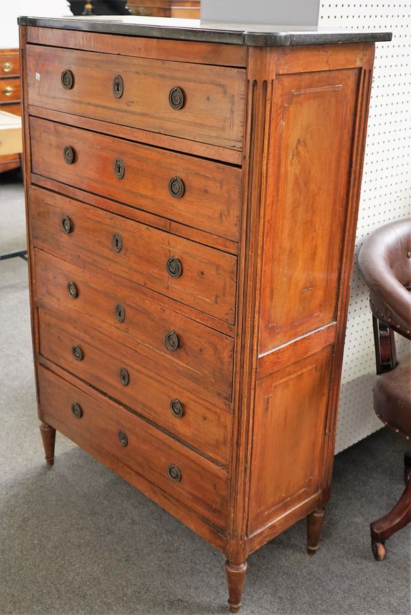 A Louis XVI provincial walnut chest, of six long drawers with harewood stringing, grey fossilised marble top, fluted angles and short turned feet, 141