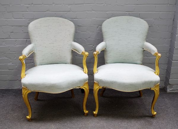 A pair of 18th century gilt framed open armchairs with serpentine seat on cabriole supports, 64cm wide x 95cm high. (2)