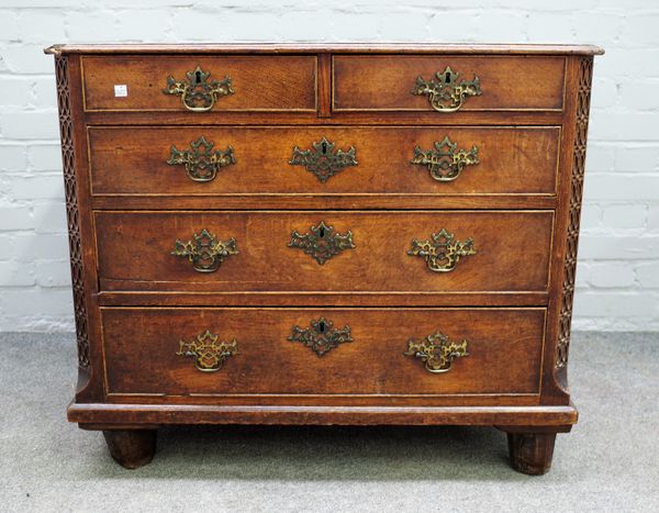 An early George III small oak chest, two short and three long drawers within blind fret angles, probably formerly on a stand, 88cms wide, 74.5cms high