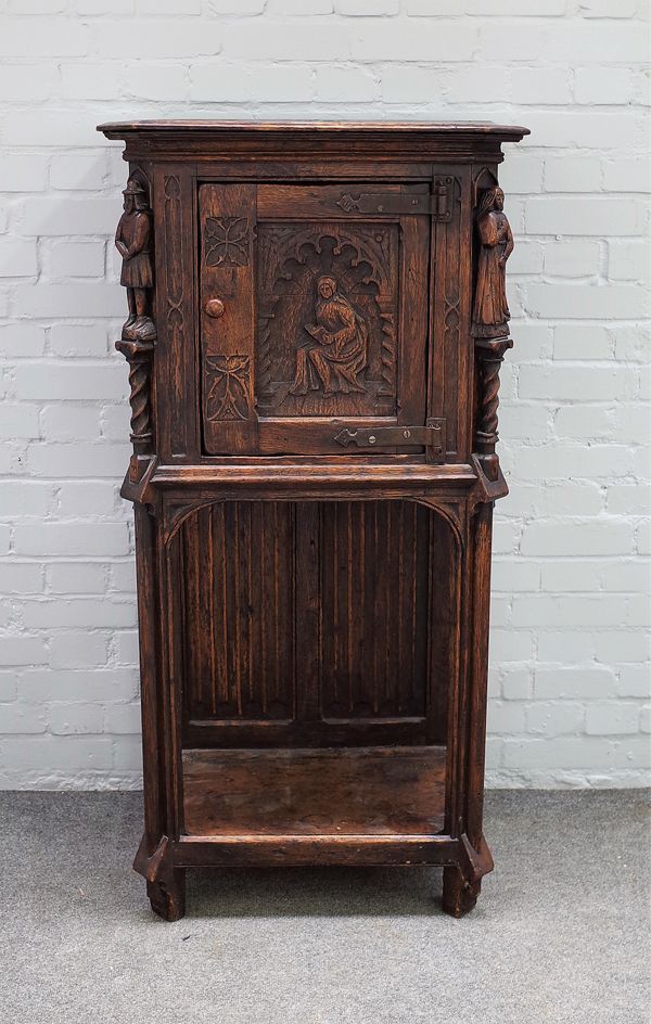 A 17th century design side cabinet, with single door with carved figural mounts, over platform undertier, with linen fold back, 19th century, 67cm wid