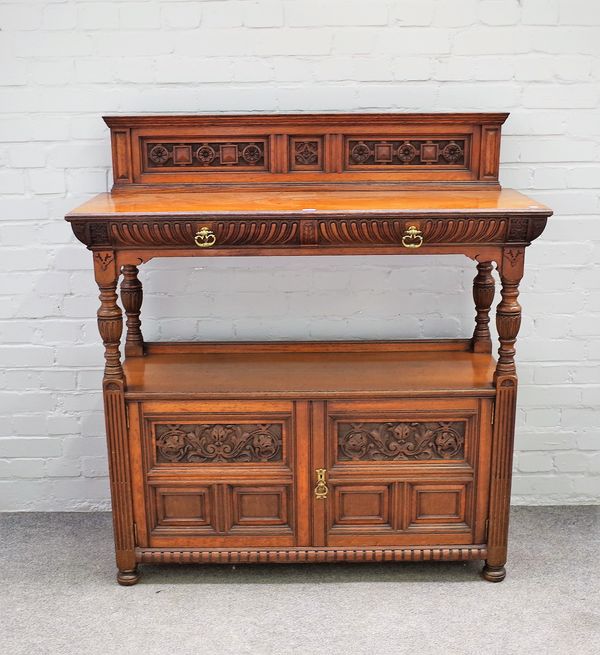 Gillow & Co; a Victorian carved oak buffet with pair of drawers over cupboard on baluster supports, stamped to drawer and numbered 9953(?), 122cm wide