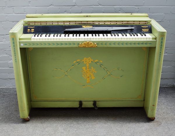 A mid-war parcel gilt and celadon decorated Eavestaff 'Minipiano', 130cms wide, 90cms high.