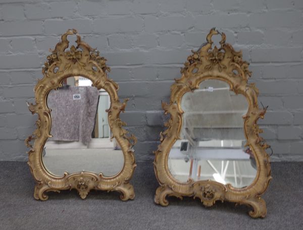 A pair of mid-19th century polychrome painted floral moulded strut mirrors, of Rococo Revival design, 48cm wide x 73cm high (2).