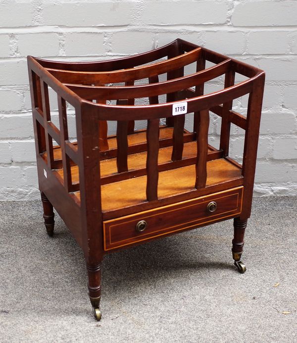 A late George III mahogany Canterbury, with two divisions and a boxwood strung frieze drawer, on ring turned legs and castors, 40cms wide, 49cms high.