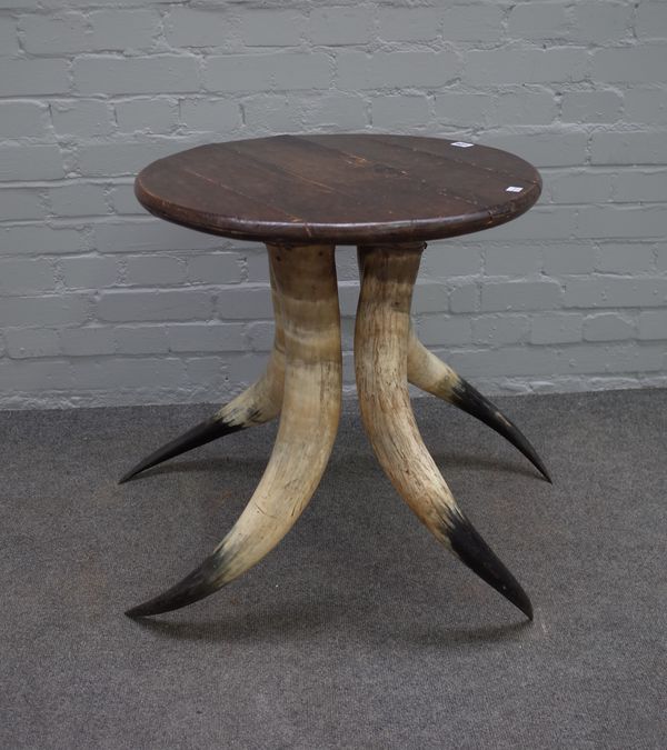 After Anthony Redmile; a 20th century occasional table on four horn supports, 56cm diameter x 64cm high.