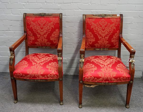 A pair of French Empire style gilt metal mounted mahogany open armchairs with caryatid mounts on tapering square supports 59cm wide x 94cm high. (2)