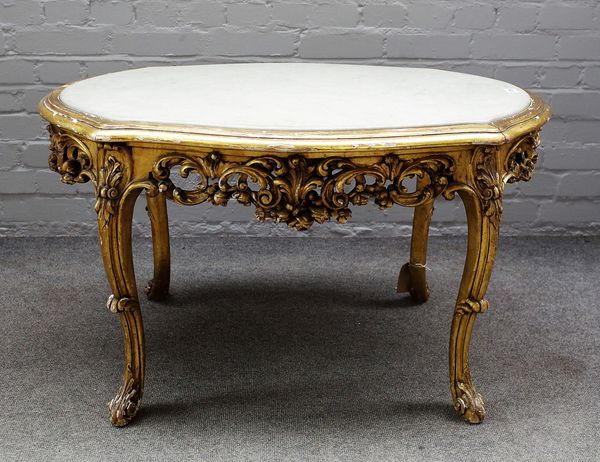 A Rococo Revival coffee table, with marble inset oval top on a profusely carved and pierced floral base and four scroll supports, 96cm wide x 57cm hig