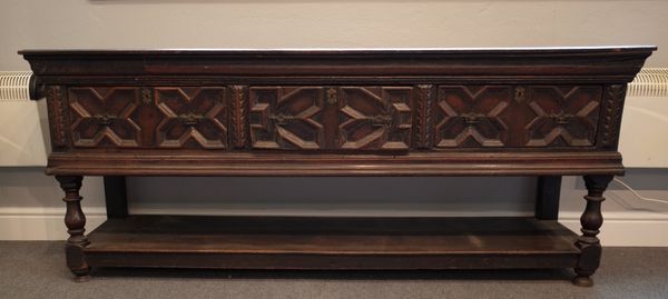 A Charles II and later oak dresser base, with three geometric moulded drawers on baluster supports united by potboard, 200cm wide x 81cm high.